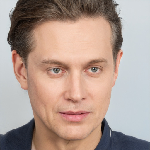 Joyful white adult male with short  brown hair and grey eyes