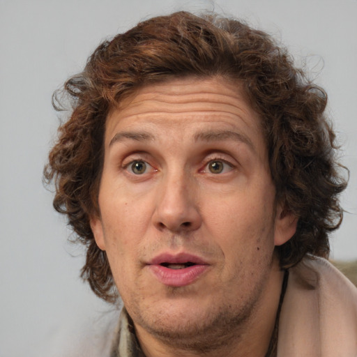 Joyful white adult male with medium  brown hair and brown eyes