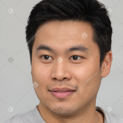 Joyful asian young-adult male with short  brown hair and brown eyes