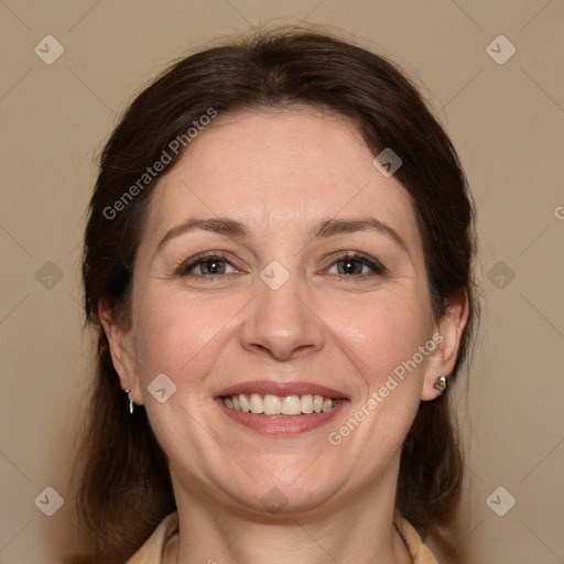 Joyful white adult female with medium  brown hair and brown eyes