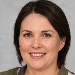 Joyful white adult female with medium  brown hair and brown eyes