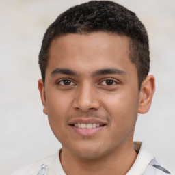 Joyful latino young-adult male with short  brown hair and brown eyes