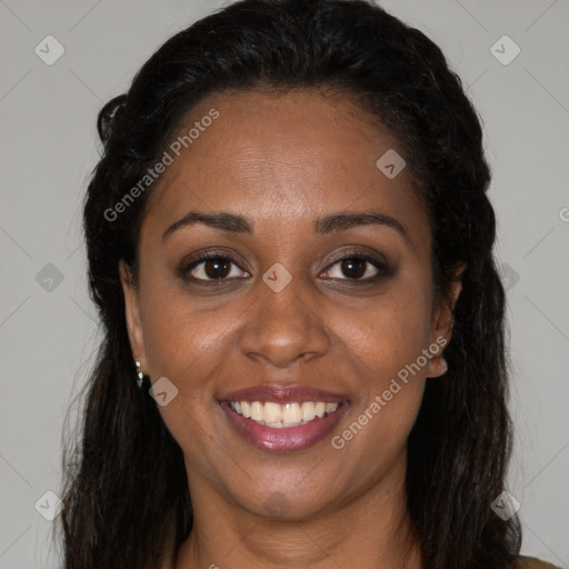 Joyful black young-adult female with long  brown hair and brown eyes