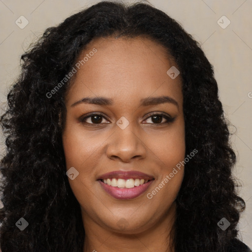 Joyful black young-adult female with long  black hair and brown eyes