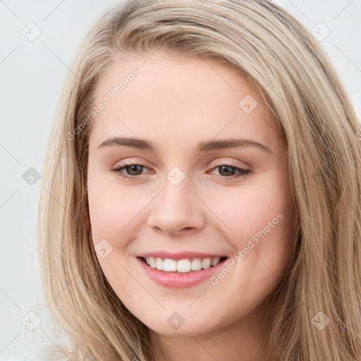 Joyful white young-adult female with long  brown hair and grey eyes