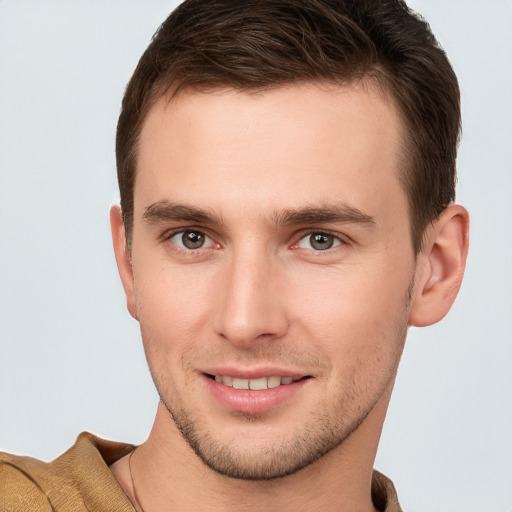 Joyful white young-adult male with short  brown hair and grey eyes