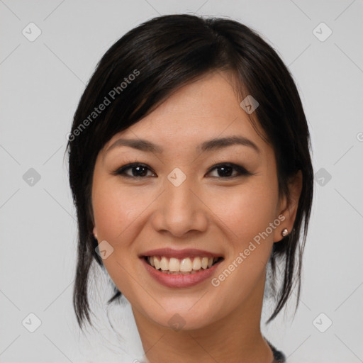 Joyful asian young-adult female with medium  black hair and brown eyes