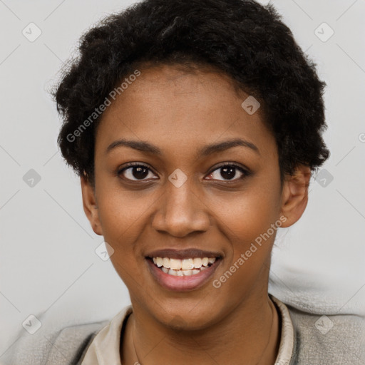 Joyful black young-adult female with short  black hair and brown eyes