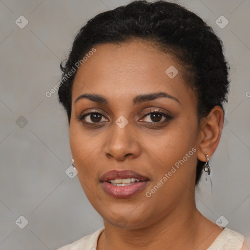 Joyful black young-adult female with short  brown hair and brown eyes