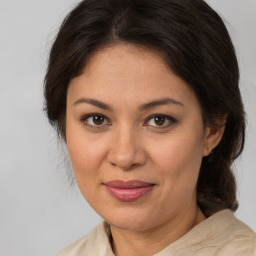 Joyful white adult female with medium  brown hair and brown eyes