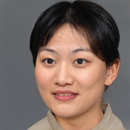 Joyful asian young-adult female with short  brown hair and brown eyes