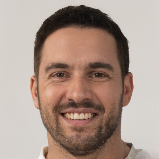 Joyful white adult male with short  brown hair and brown eyes