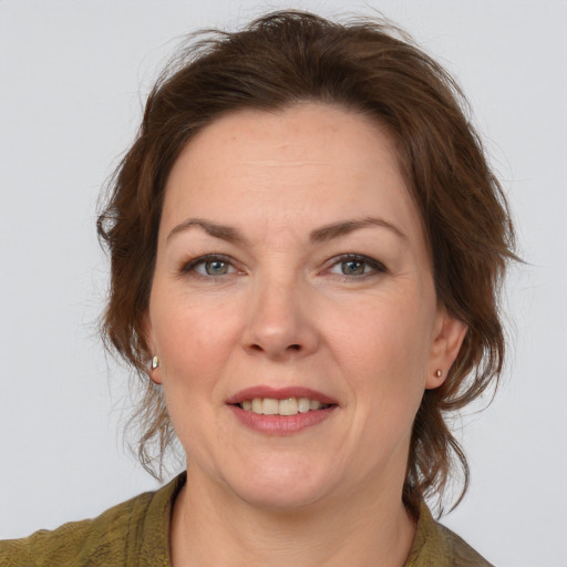 Joyful white adult female with medium  brown hair and brown eyes