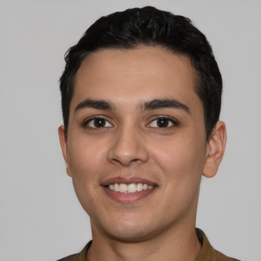 Joyful white young-adult male with short  black hair and brown eyes