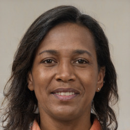 Joyful white adult female with long  brown hair and brown eyes