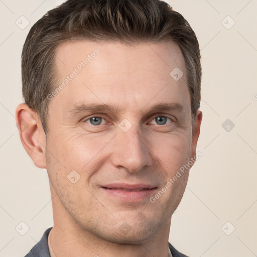 Joyful white adult male with short  brown hair and grey eyes