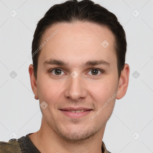 Joyful white young-adult male with short  brown hair and grey eyes