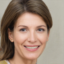 Joyful white young-adult female with medium  brown hair and grey eyes