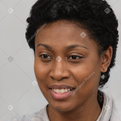 Joyful black young-adult female with short  black hair and brown eyes