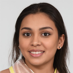 Joyful white young-adult female with long  brown hair and brown eyes