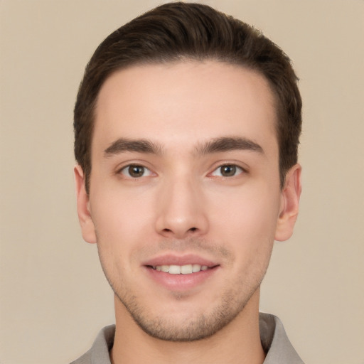 Joyful white young-adult male with short  brown hair and brown eyes