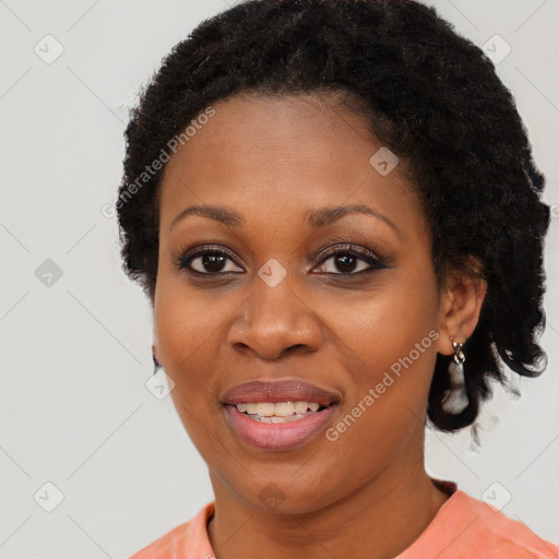 Joyful black adult female with short  black hair and brown eyes