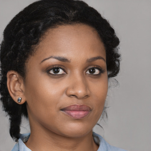 Joyful black young-adult female with medium  brown hair and brown eyes