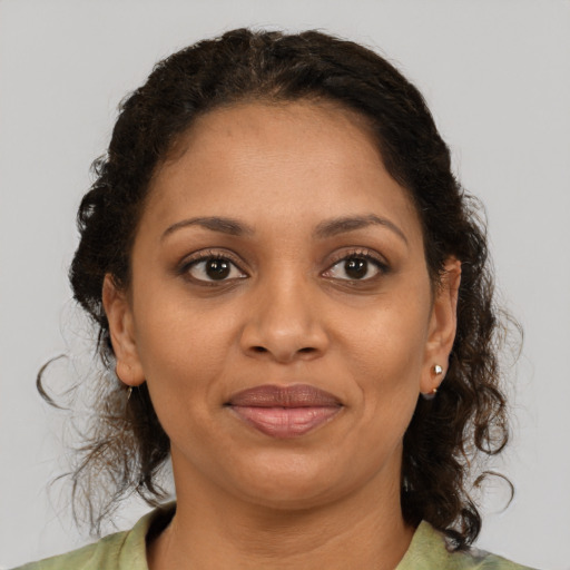 Joyful black young-adult female with medium  brown hair and brown eyes
