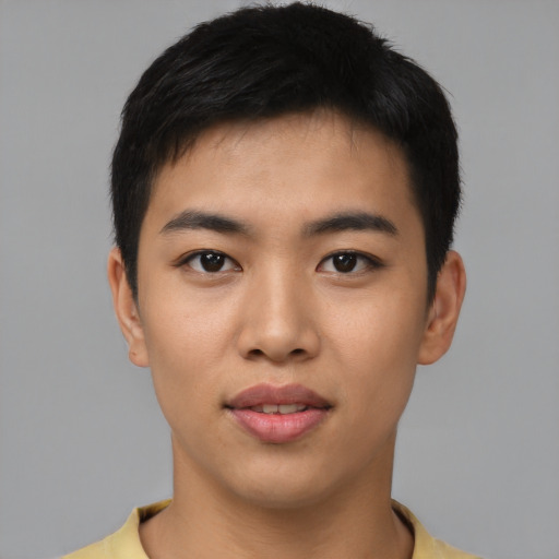Joyful asian young-adult male with short  black hair and brown eyes