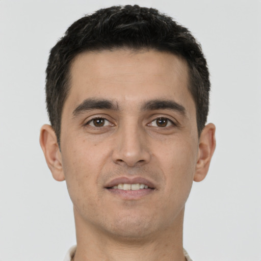 Joyful white young-adult male with short  black hair and brown eyes