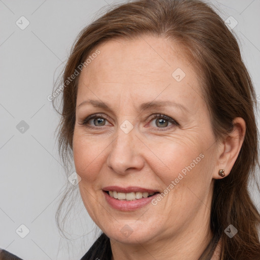 Joyful white adult female with long  brown hair and brown eyes