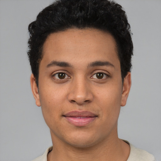Joyful latino young-adult male with short  brown hair and brown eyes
