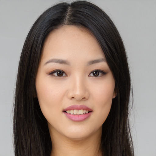 Joyful asian young-adult female with long  black hair and brown eyes