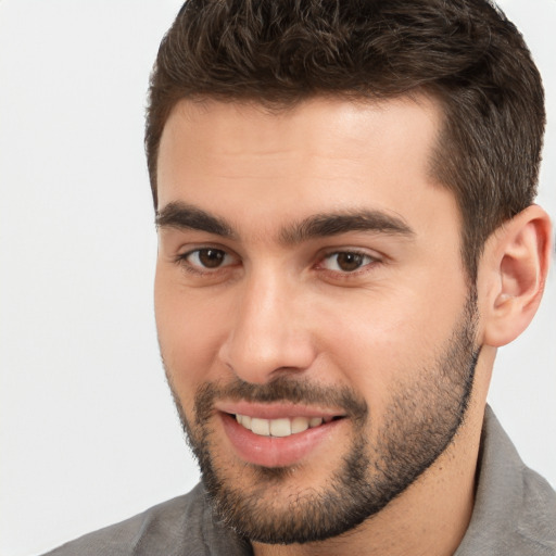 Joyful white young-adult male with short  brown hair and brown eyes