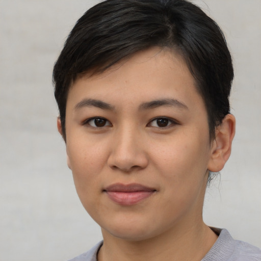 Joyful asian young-adult female with short  brown hair and brown eyes