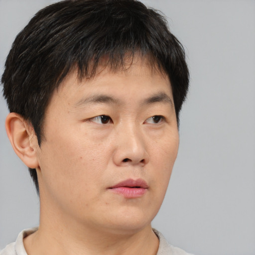 Neutral asian young-adult male with short  brown hair and brown eyes