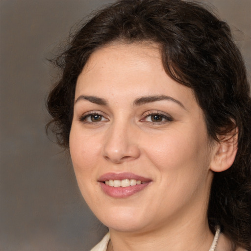 Joyful white young-adult female with medium  brown hair and brown eyes