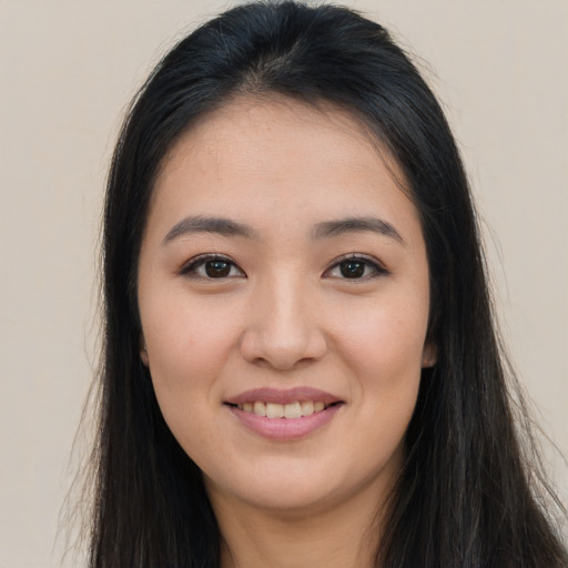 Joyful asian young-adult female with long  brown hair and brown eyes