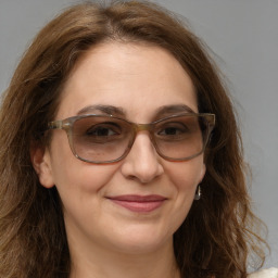 Joyful white adult female with long  brown hair and brown eyes