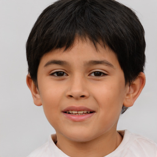 Joyful asian child male with short  brown hair and brown eyes