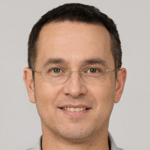 Joyful white adult male with short  brown hair and brown eyes