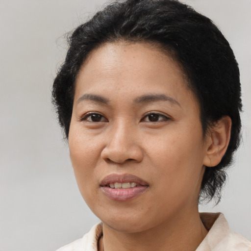 Joyful latino young-adult female with short  black hair and brown eyes