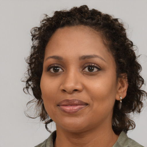 Joyful black young-adult female with medium  brown hair and brown eyes