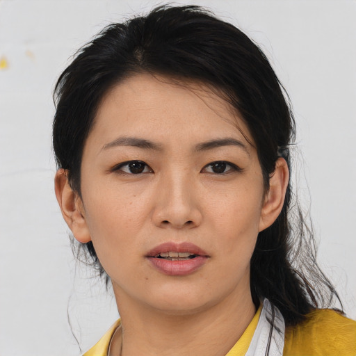Joyful asian young-adult female with medium  black hair and brown eyes