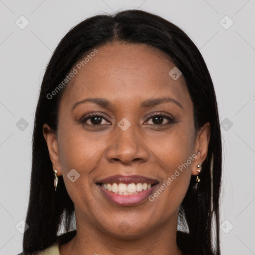 Joyful black young-adult female with long  brown hair and brown eyes