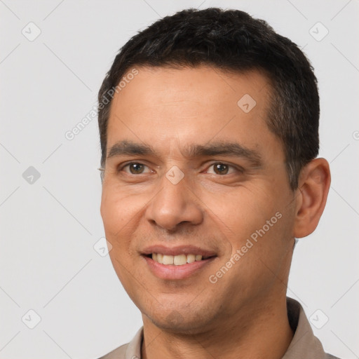 Joyful white young-adult male with short  black hair and brown eyes