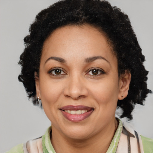 Joyful latino adult female with short  brown hair and brown eyes