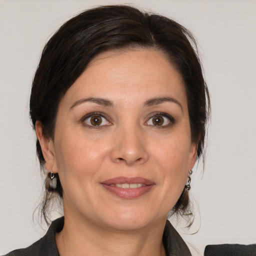 Joyful white adult female with medium  brown hair and brown eyes