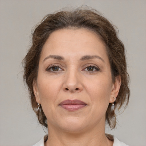 Joyful white adult female with medium  brown hair and brown eyes