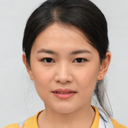 Joyful asian young-adult female with medium  brown hair and brown eyes